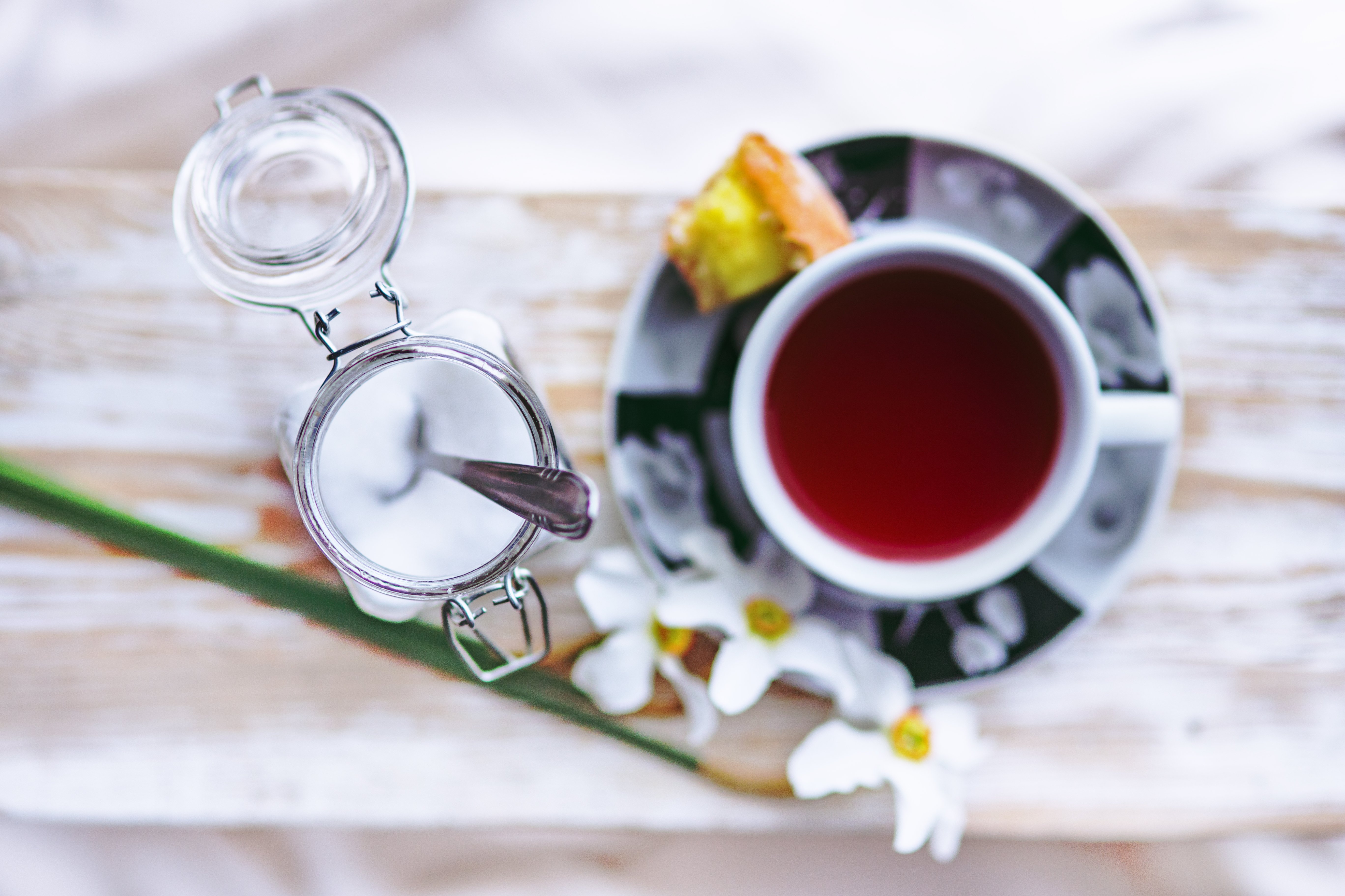Overhead view of tea in a up with a cup of sugar next to it